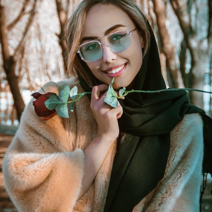 Kaveri Mehta, Lead Design Curator at Atlas Wood Fall, reviewing corporate floral arrangements